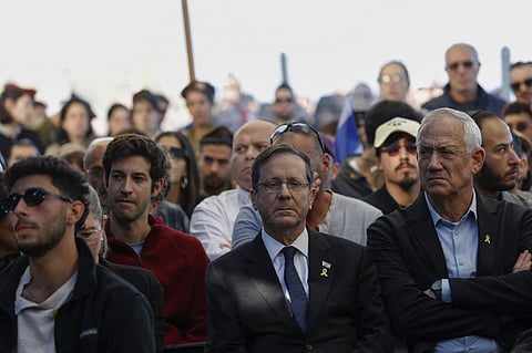 Israel President Isaac Herzog (C) and opposition lawmaker Benny Gantz attend the funeral of Israeli Staff Sergeant Oron Shaul in the northern Israeli town of Poria Illit on January 20, 2025. Israel said on January 19, that it had recovered the body of a soldier killed in combat in 2014 and held in Gaza by Hamas ever since. The Israeli prime minister said in a statement that the body of Oron Shaul, who was killed on July 20, 2014, was recovered in an operation by the army and the Shin Bet security agency.