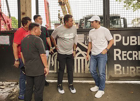 MANILA Mayor Isko Moreno (right), during his visit to the Sta. Cruz covered court, halted the demolition of a senior citizens’ office for lacking a permit.