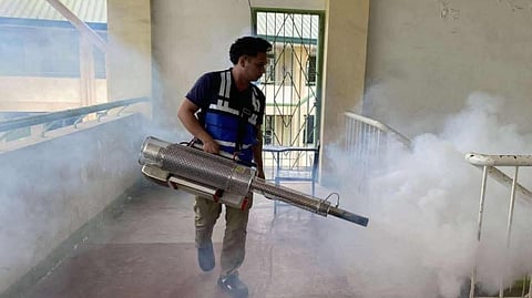 A worker from the Manila Disaster Risk Reduction and Management Operations Team uses a machine to conduct fogging and eliminate mosquitoes amid the reported rise of dengue cases.