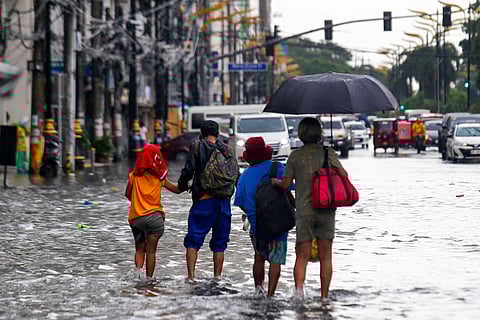 A sudden afternoon downpour led to gutter-deep flooding along Kalaw Avenue in Manila