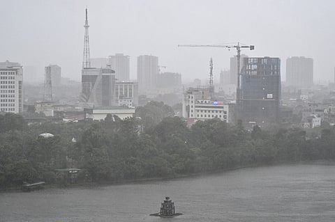 A general view shows a river and buildings amid heavy rain and strong winds in Vinh city, Nghe An province, on 25 August 2025, after Typhoon Kajiki made landfall. Vietnam evacuated tens of thousands of residents from coastal areas on August 25, as Typhoon Kajiki made landfall, lashing the country's central belt with gales of more than 130 kilometres per hour.