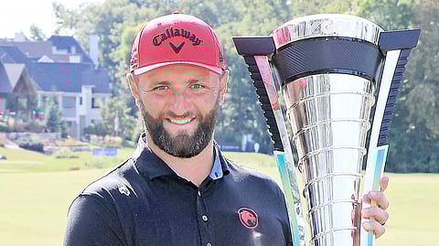 JON Rahm of Legion XIII lifts the trophy after ruling the LIV Golf League team final in Michigan.