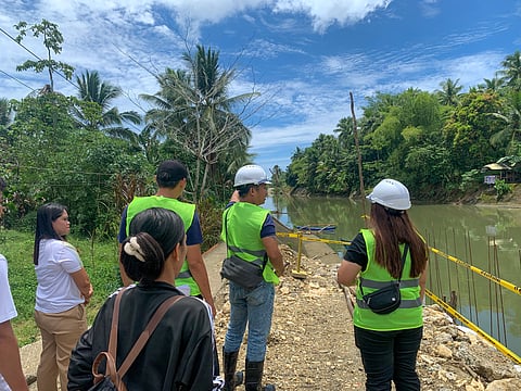 Officials from the Development Bank of the Philippines lead an on-site inspection along the banks of the Lo-om River to assess the ongoing infrastructure works aimed at mitigating flood risks and strengthening community resilience against climate-related hazards.