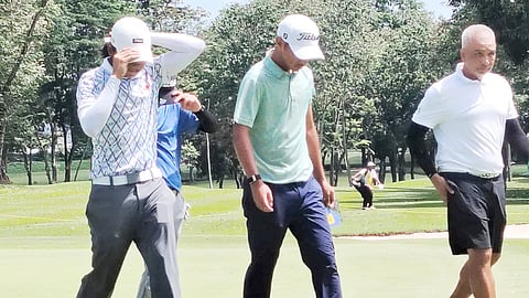 Vito Sarines, Apollo Batican (partly covered), Zianbeau Thurs Edoc and Don Breganza walk off the 18th green during the opening round of the Philippine Amateur Championships.