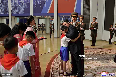 NORTH Korean leader Kim Jong Un embraces a family member of a soldier who participated in overseas military operations in Pyongyang.