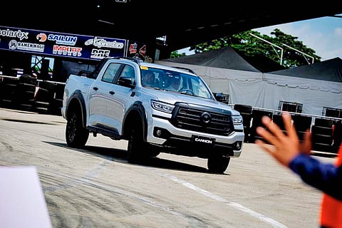 GWM Cannon pickup takes on the test course at a driving event.