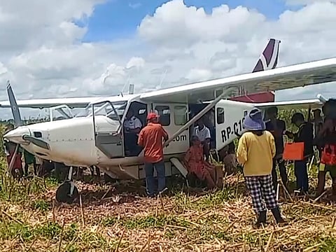 Authorities check on the seven passengers — including the pilot — after a Sky Pasada airplane makes an emergency landing at Barangay District 1 in Reina Mercedes, Isabela on Sunday. The passengers and the pilot are all safe.