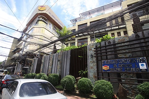 BUREAU of Customs personnel conduct an inspection of luxury vehicles owned by Gerald Construction Company, a business of the Discaya family in Pasig City, on Tuesday. Authorities confiscated two luxury cars during the operation.