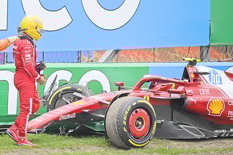 BRITISH driver Lewis Hamilton looks at his car after crashing during the Formula One Dutch Grand Prix at The Circuit Zandvoort.