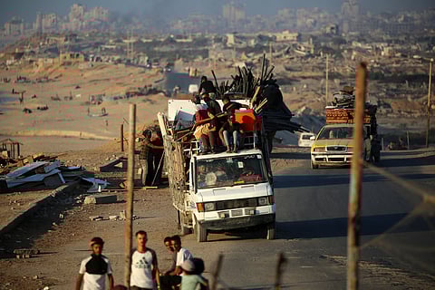 Palestinians fleeing south, ride a truck with their belongings, on the coastal road near the Nuseirat camp in the central Gaza Strip, on August 5, 2025. Despite mounting pressure at home and abroad to halt its nearly two-year offensive in Gaza, Israel has been calling up reservists, intensifying its bombardments and closing in on Gaza City ever since announcing its intention to capture the Palestinian territory's largest city.