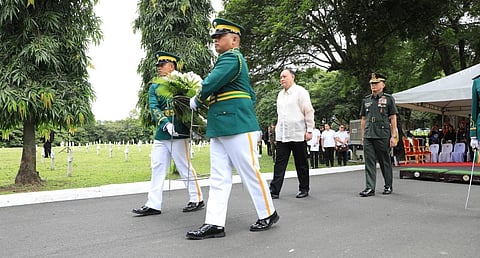 DEFENSE Secretary Gilberto C. Teodoro Jr. (right) lays a wreath at the Korean War Memorial Pylon in Libingan ng mga Bayani, Taguig City, on Friday to honor the veterans of the Philippine Expeditionary Force to Korea.