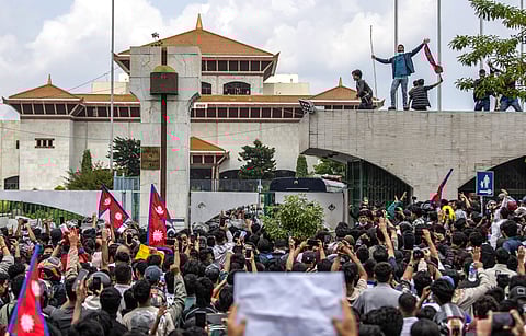 Demonstrators gather outside Nepal’s Parliament during a protest in Kathmandu on 8 September 2025, against social media prohibitions and corruption by the government. Nepal police opened fire, killing at least 17 people as thousands of young protesters took to the streets of Kathmandu demanding the government lift a social media ban and tackle corruption.