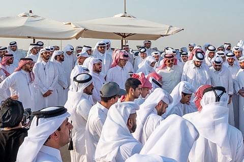 This handout picture made available by the Qatar Amiri Diwan, shows Qatar's Emir Sheikh Tamim bin Hamad Al-Thani attending the funeral of people killed in an Israeli strike on figures of the Palestinain Hamas movement two days earlier, at the Mesaimeer cemetery in Doha on 11 September 2025. On 9 September, Israel struck Doha targeting Hamas leaders, but the group said its top officials survived, while five of its members were left dead and a Qatari security force member was also killed. In an interview with CNN the following day, Qatar's Prime Minister said he hoped for a collective regional response to the attack and that an Arab-Islamic summit would be held in Doha to decide on a course of action.