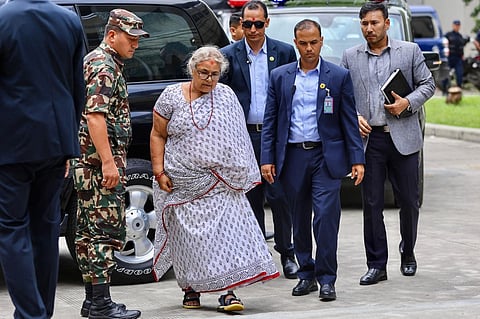Newly-elected Prime Minister of Nepal’s interim government Sushila Karki (2L) arrives at the Civil Service Hospital to visit victims injured during clashes with security personnel, in Kathmandu on September 13, 2025. Nepal's capital on September 13, took a step back towards normality after deadly anti-corruption protests, as daily life returned with a curfew eased and an interim prime minister sworn into office.