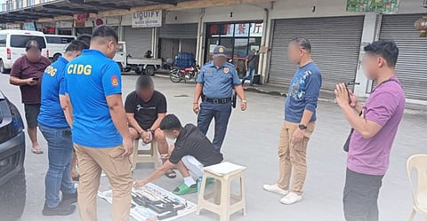 Authorities check on the illegal firearms that were confiscated from a Philippine Coast Guard member who allegedly sells loose weapons during the entrapment operation conducted by the Criminal Investigation and Detection Group.