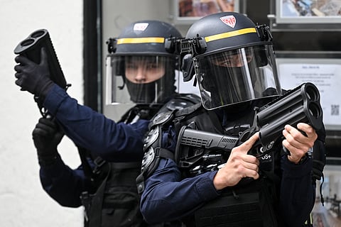 ANTI-RIOT police officers hold tear gas canister launchers while ensuring the peace during a demonstration, in Nantes, France in relation to the Bloquons tout (‘Let’s block everything’) protest movement.