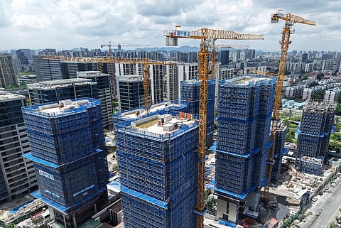Buildings are seen under construction in Hangzhou, in China’s eastern Zhejiang province on 15 September 2025. China's economy showed further signs of weakness last month, with key data on September 15 revealing factory output and consumption rising at their weakest pace for around a year.