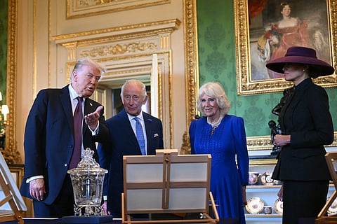 US President Donald Trump, Britain's King Charles III, Britain's Queen Camilla and US First Lady Melania Trump view items from the Royal Collection in the Green Drawing Room at Windsor Castle, in Windsor, on 17 September during the US President's second State Visit. US President Donald Trump arrived in Britain for an unprecedented second State Visit, with the UK government rolling out a royal red carpet welcome to win over the mercurial leader.
