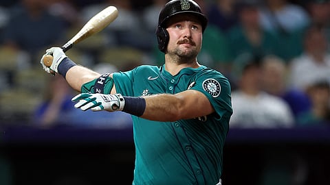 CAL Raleigh of the Seattle Mariners smashes one of the two home runs that broke the MLB record for most homers by a switch-hitter in a season during their game against the Kansas City Royals.