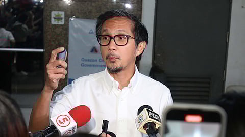 DPWH Secretary Vince Dizon shows a USB drive said to contain data on ghost flood projects in Quezon City.
