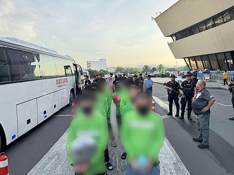 Deported Chinese nationals board a flight to Shanghai at NAIA Terminal 1 on 19 September.