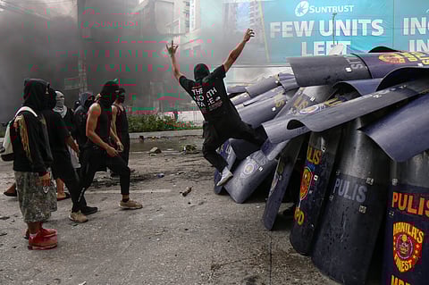 Phalanx Masked and hooded men attack a squad of police officers huddled behind their shields in Manila, igniting a night of chaos on 21 September, 53 years to the day of Ferdinand Marcos Sr.’s proclamation of Martial Law.