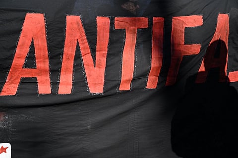 A banner reading 'Antifa' is pictured during a demostration under the motto "Block Alice Weidel" (The co-leader of the far-right Alternative for Germany (AfD) party), during an AfD campaign meeting in Neu-Isenburg near Frankfrurt am Main, western Germany, on February 1, 2025.