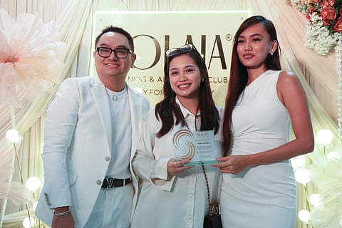 Dr. Ryan Empleo and Dr. Givenchy Ang with an attendee at the SOLAIA event.
