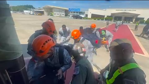 Rescue teams board a helicopter on the way to Cebu to provide assistance in search and rescue operations following the magnitude 6.9 earthquake.