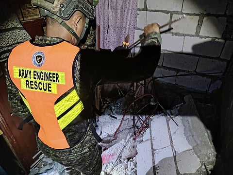 Personnel from the ESC, 53rd Engineer Brigade removes debris and obstacles to retrieve a cadaver following a 6.9-magnitude earthquake in areas of San Remigio and Medellin Cebu on September 30, 2025.