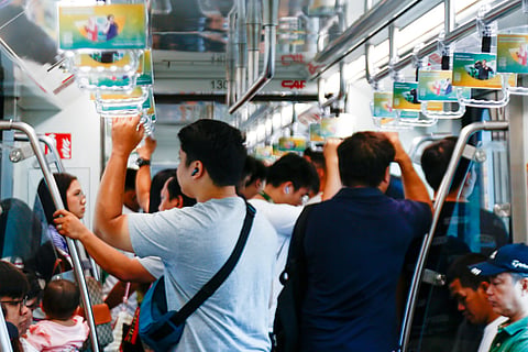 Commuters of the LRT-1 patiently wait for the train to get to their destinations on Thursday morning. The LRT-1 spans from Fernando Poe Jr. Station on Quezon City to Dr. Santos Station in Parañaque City.