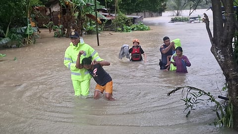 POLICE officers from Cabangan Municipal Police Station evacuate residents trapped by flooding in Barangay Longos, Cabangan, Zambales, caused by typhoon ‘Paolo.’
