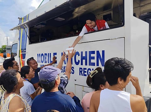 DSWD Field Office VI staff serve hot meals to residents affected by the recent earthquake in San Remigio, Cebu, through the agency’s mobile kitchen. Coordinated with DSWD Field Office VII, the initiative is part of ongoing efforts to deliver immediate relief and support to disaster-hit communities.