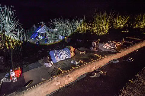WITH aftershocks continuing, some residents (top photo) were forced to sleep outside their homes. Cebu Governor Pamela Baricuatro (lower photo) visits Barangay Kantubaon in Tabuelan, where several families — including public servants — were among the hardest hit by the recent 6.9-magnitude earthquake.