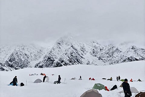 HIKERS amid deep snow at Tangxiang camp in the Karma Valley of the Tibet Autonomous Region on 5 October 2025, following a sudden heavy snowfall in the region.