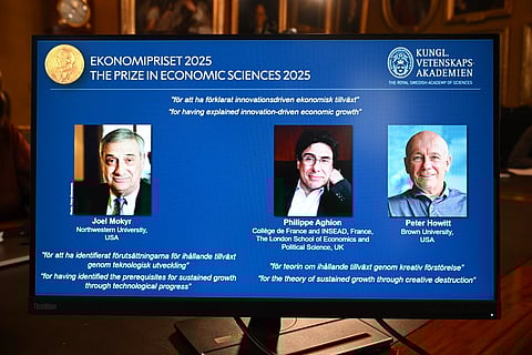 A screen displays the portraits of the 2025 prize winners (L-R) Joel Mokyr, Philippe Aghion and Peter Howitt, during the announcement of the winners of the 2025 Nobel Prize in Economics, the Sveriges Riksbank Prize in Economic Sciences in Memory of Alfred Nobel, at the Royal Swedish Academy of Sciences in Stockholm, Sweden, on October 13, 2025. The Nobel prize in economics was awarded to American-Israeli Joel Mokyr, France's Philippe Aghion and Canada's Peter Howitt for work on technology's impact on sustained economic growth.
