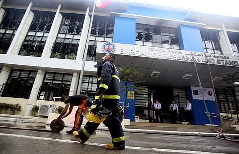 Firefighters race against time to douse the blaze that razed the Department of Public Works and Highways building along EDSA in Quezon City on Wednesday.