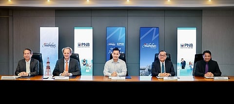 (FROM left) PAL Executive Vice President / Chief Operating Officer Atty. Carlos Luis Fernandez, PAL President Richard Nuttall, Lucio Tan Group Inc. and PAL Holdings Inc. President and Chief Operating Officer Lucio C. Tan III, PNB President and Chief Executive Officer Edwin Bautista and PNB Chief Financial Officer Francis Albalate at the signing of the memorandum of agreement held recently at the Lucio K. Tan Jr. Center in Pasay City.