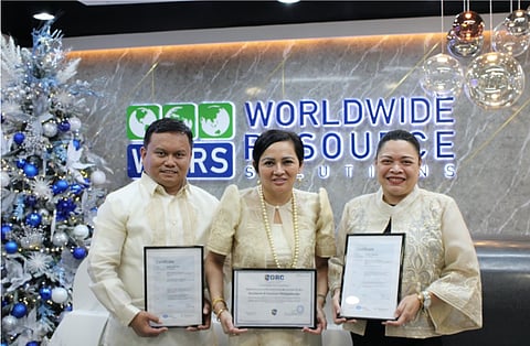WWRS Philippines Inc. senior leaders in their traditional Filipino attire, (from left) Vice President Tony Monteras, Managing Director Rosita Lara “Otty” Lumagui, and Risk & Compliance Director Marge Longa proudly display the company’s ISO-27001:2022 and HIPAA certificates, emphasizing its commitment to international standards.