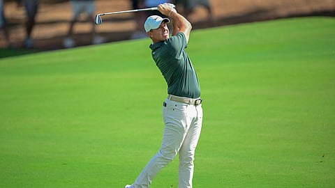 Northern Ireland’s Rory McIlroy plays a shot from the fairway at the first hole on day one of the DP World Tour Championship 2025 golf tournament at Jumeirah Golf Estates in Dubai on 13 November 2025.