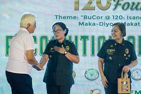 DR. Bernardita C. Navarro (left), medical director of the Tzu Chi Eye Center, thanks Maria Fe R. Marquez, head executive assistant of the Office of the Director General of BuCor, for the award.