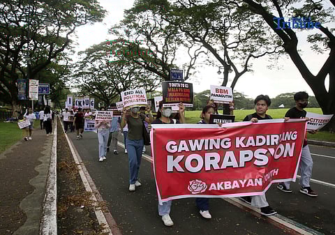 Student Youth Against Kurakot members march around the University of the Philippines–Diliman academic oval in celebration of International Students’ Day, holding placards bearing a symbolic “guilty verdict” against government officials linked to the flood control scandal. The youth group called for accountability and reforms as they staged their protest on campus in Quezon City.