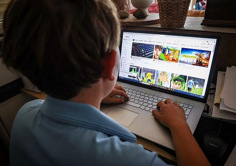 This photo taken on October 24, 2025 shows a fourteen-year-old boy posing at his home near Gosford as he looks at social media on his computer. Australians younger than 16 will be removed from Facebook and Instagram on December 4, tech giant Meta said on November 20, 2025, as Canberra prepares to enforce sweeping laws banning teens from social media.
