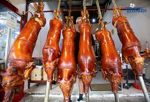 (November 28 2025) Workers arrange their freshly cooked lechon (roasted pigs) at Rix’s lechon in La Loma Quezon City the Lechon Capital of the Philippines on Friday November 28 2025.