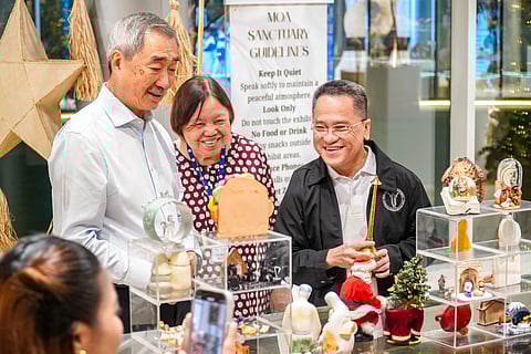 SM Prime Chairman, Mr. Hans Sy, Rose Siaco, and Fr. Genaro Diwa, admiring the Belens and Christmas decorations at the Halina sa Belen exhibit.