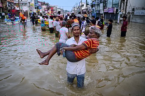 A YOUTH carries an elderly man as they wade through a flooded street after heavy rainfall in Wellampitiya on the outskirts of Colombo, Sri Lanka on 30 November 2025. The death toll from floods and landslides triggered by ‘Cyclone Ditwah’ has risen to at least 334 people across Sri Lanka, with nearly 400 still missing, the Disaster Management Centre said.