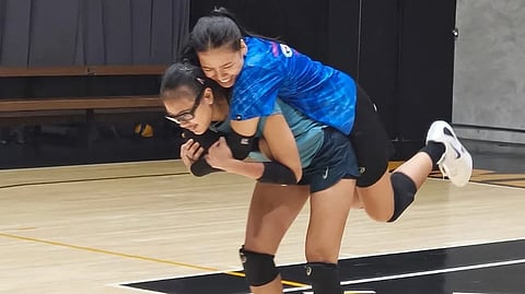 SHAINA Nitura playfully carries Eya Laurel during their training for Alas Pilipinas ahead of the women’s volleyball event of the 33rd Southeast Asian Games.