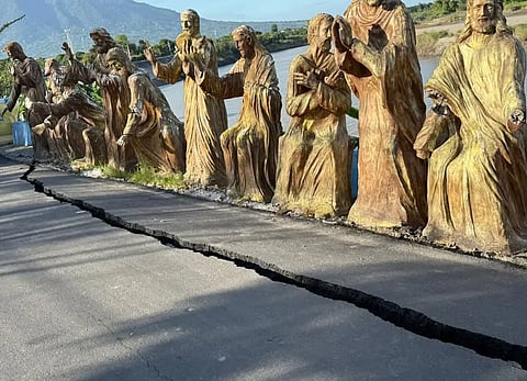A huge crack is seen along the road of the Arnedo Dike in the town of Arayat, Pampanga on December 4, 2025, creating concern on the safety of the area.