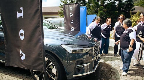 VISITORS take a closer look at the Volvo XC60 on display during the tournament.