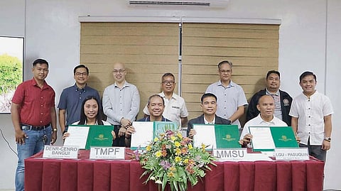 FORMALITIES mark the signing of the coastal forest conservation agreement among TMP Foundation, MMSU, DENR-CENRO Bangui, and the Pasuquin local government. Shown are: (from left, front) DENR-Community Environment and Natural Resources Office Bangui Ecosystem Management specialist I Justine Rose Teneza, TMP Foundation president Jose Maria Aligada, MMSU president Dr. Virgilio Julius Manzano Jr., and Municipal Government of Pasuquin Environmental Protection Committee chair Romel Ranay, together with other TMP network officers and MMSU officials, during the signing of the memorandum of agreement for the Coastal Forest Conservation Project.